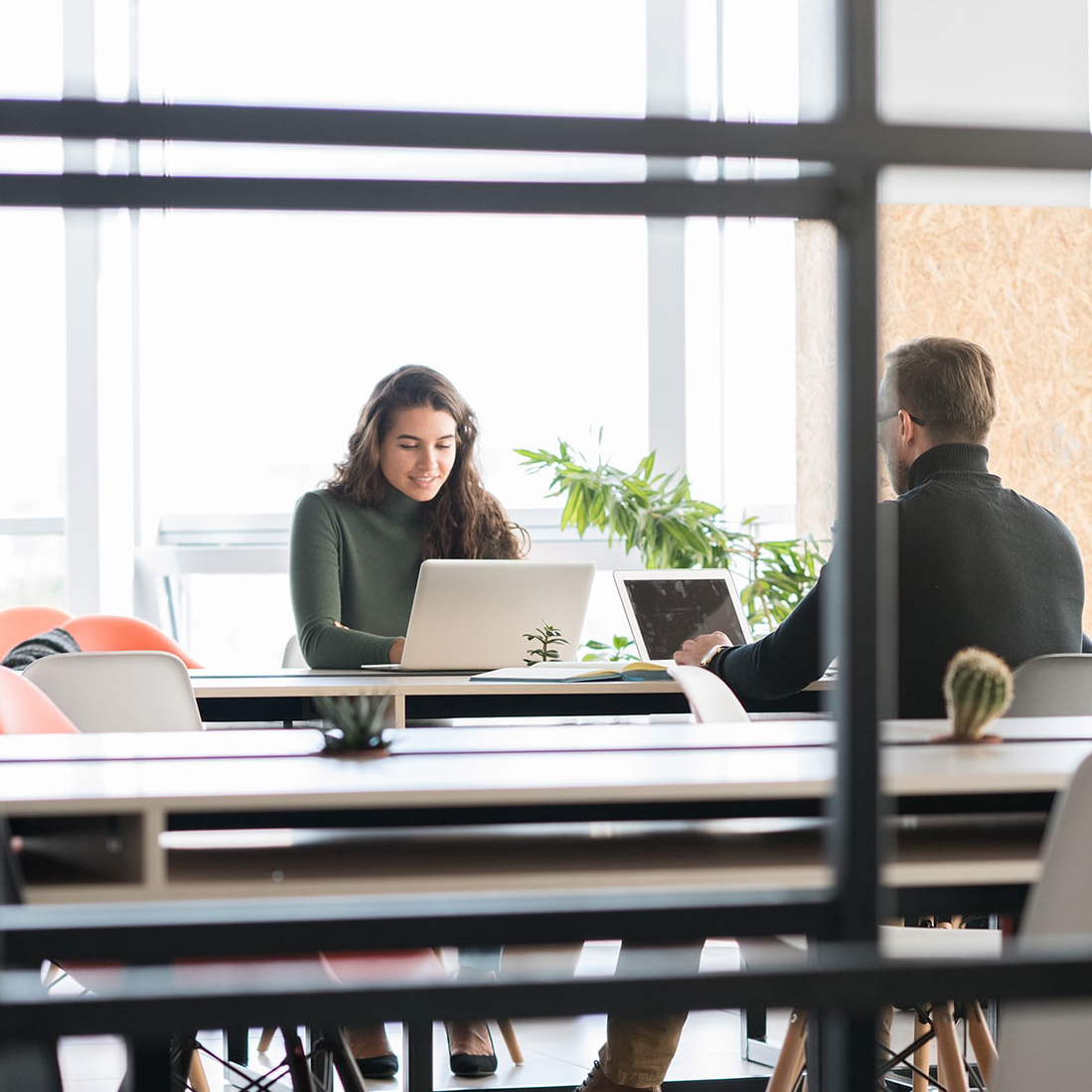 Zwei Geschäftsleute arbeiten mit Laptops im Coworking Space unique Hotels