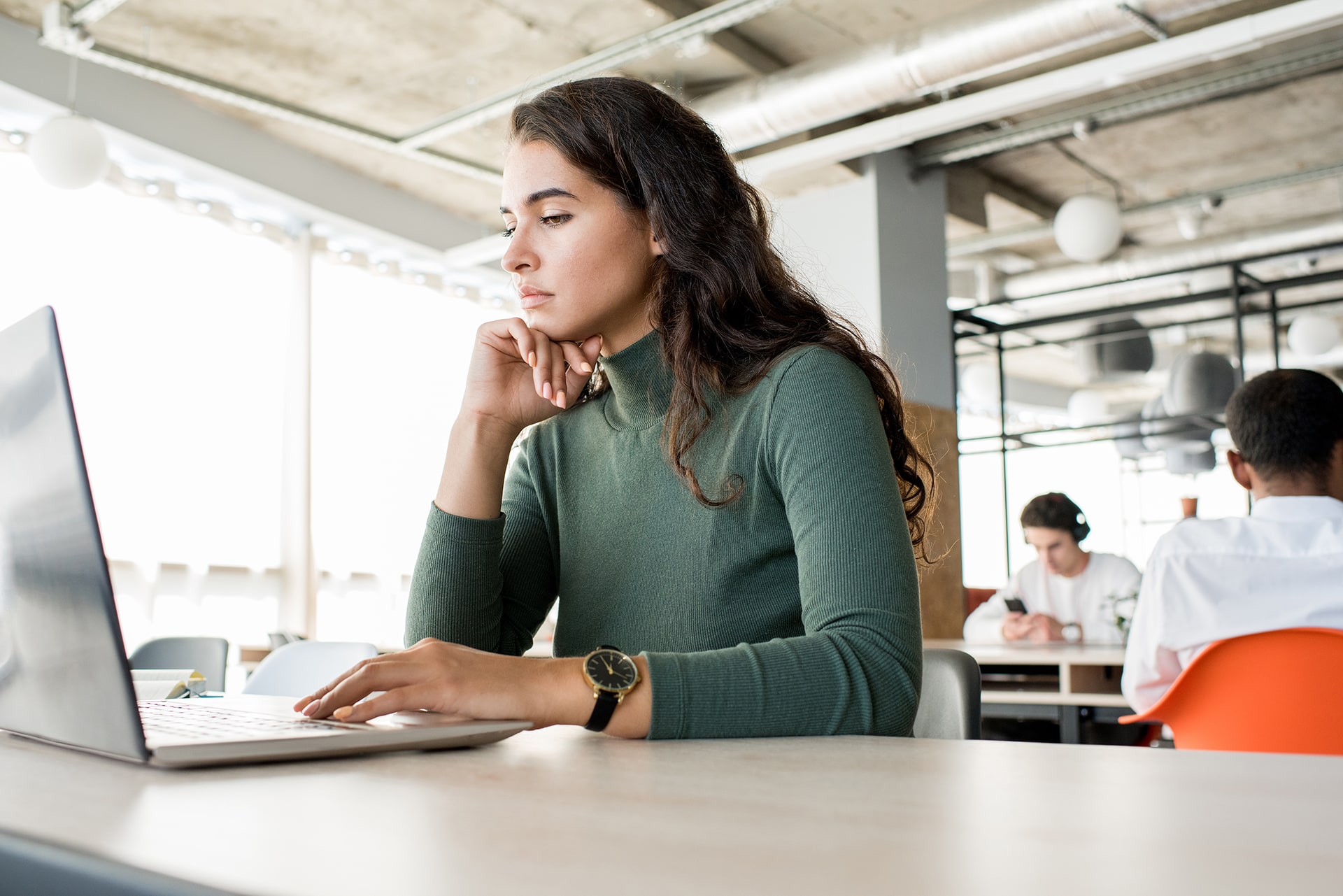 Woman with laptop in the coworking space in the unique of ATLANTIC Hotels